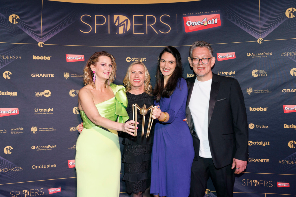 team posing with spider award